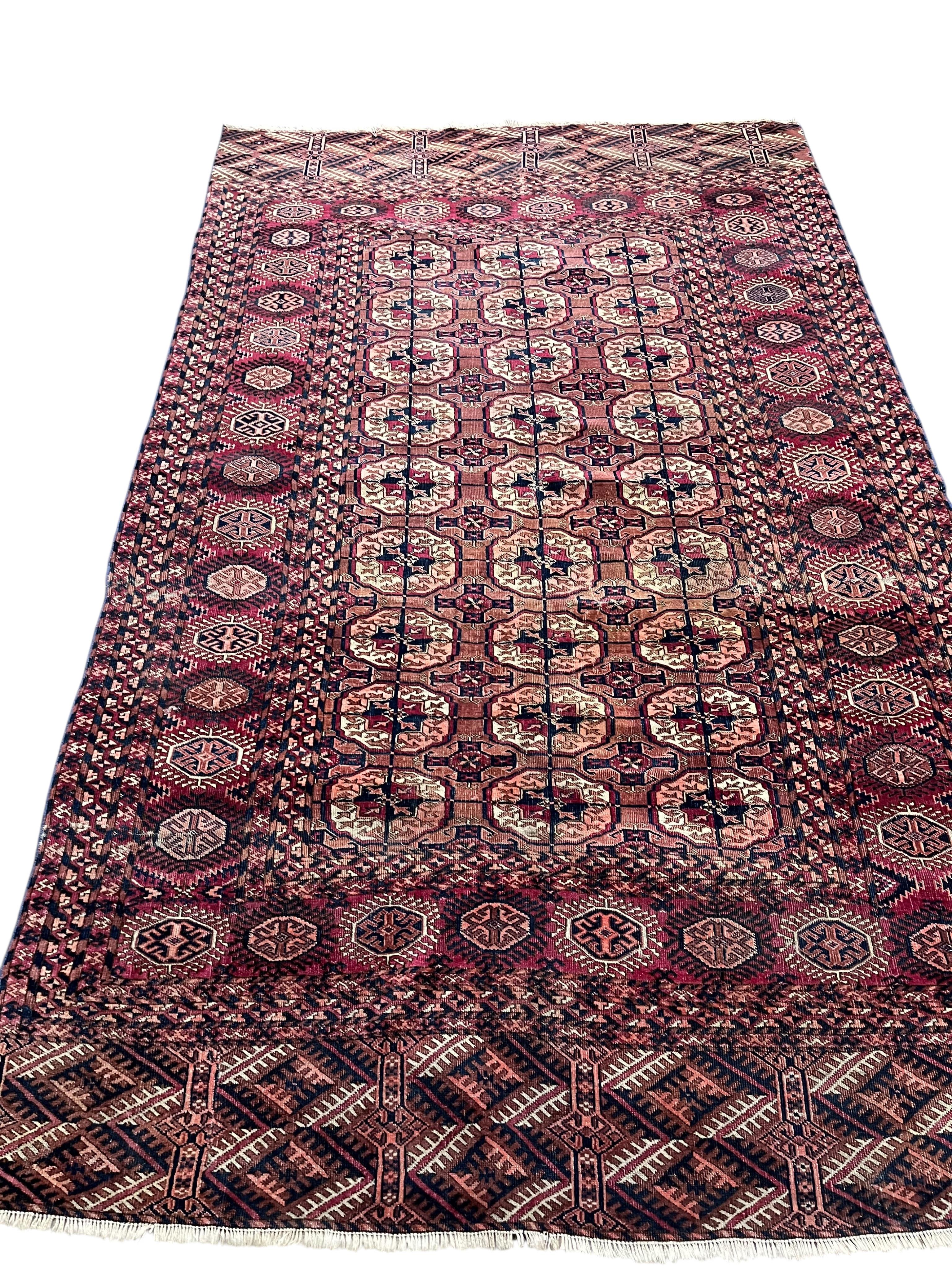 A Bokhara red ground rug, 190 x 132cm